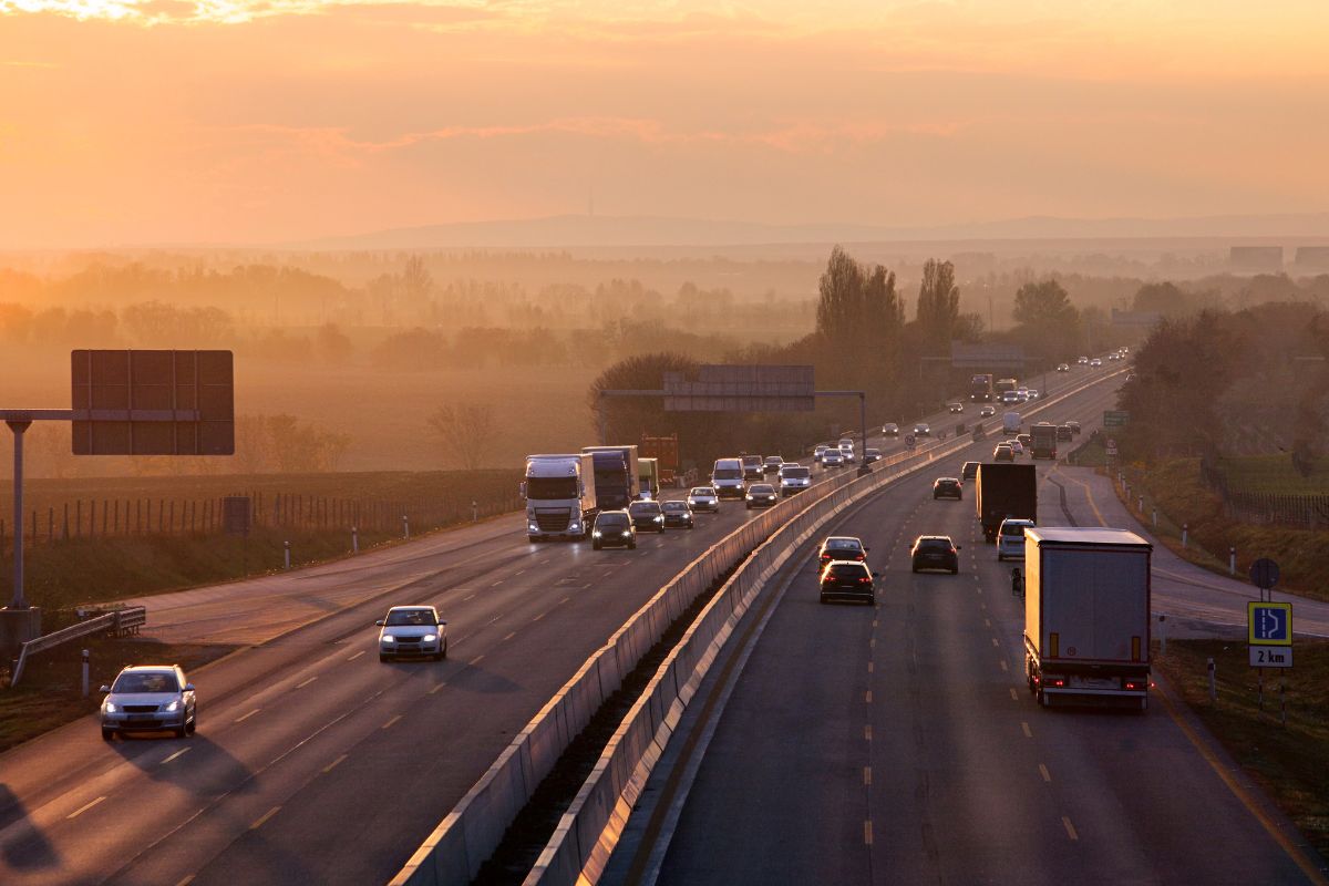 An interstate highway with a lot of cars on it.